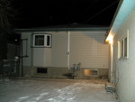 PC074939
Picture from back.  Grade slopes noticably away from house, but crowns near garage side-access door, leading in to house again.